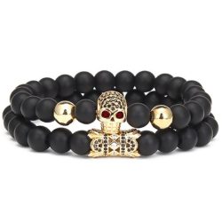   Páros ásvány karkötő - matt fekete ónix - aranyszínű koponya cirkónium kristályokkal - alagút charm liliom szimbólummal - 2 db-os szett