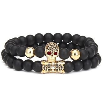   Páros ásvány karkötő - matt fekete ónix - aranyszínű koponya cirkónium kristályokkal - alagút charm liliom szimbólummal - 2 db-os szett